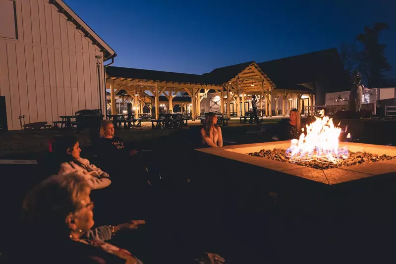 group of friends hanging out by the fire at SkyLand Ranch