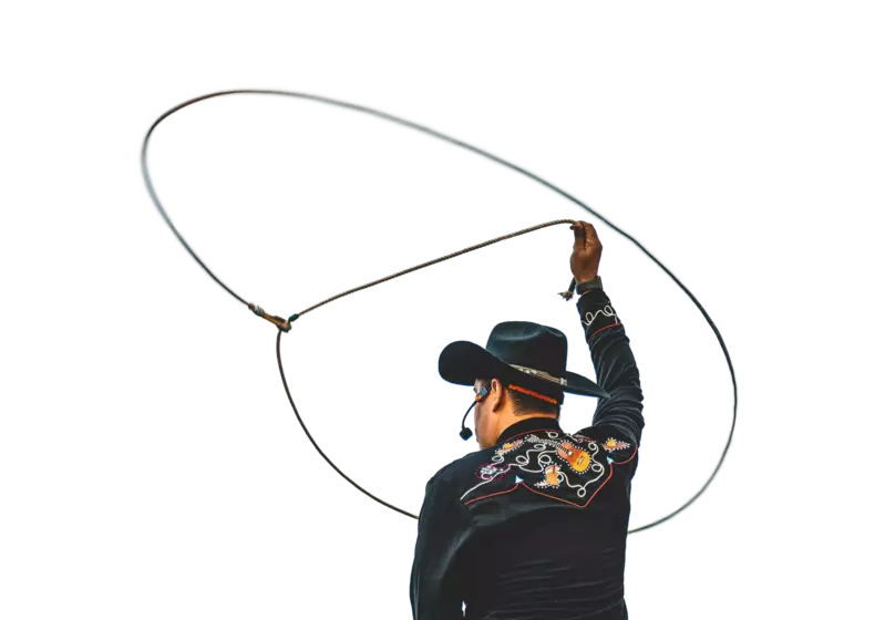 man throwing a lasso up into the air 