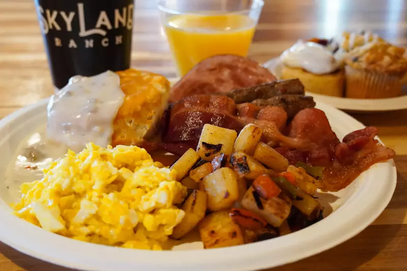 breakfast plate with scrambled eggs potatoes and more